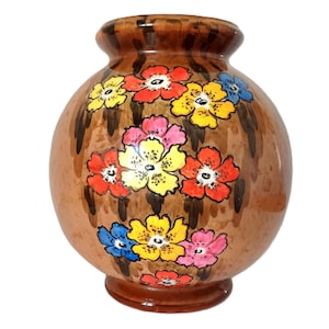 May include: A brown ceramic vase with a round body and a narrow neck. The vase is decorated with colourful flowers in shades of red, yellow, blue, and pink.
