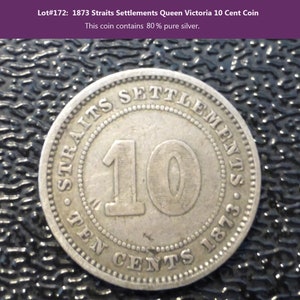 May include: A silver 10 cent coin from the Straits Settlements, dated 1873. The coin features the text "Straits Settlements" and "Ten Cents 1873" around the edge, with the number "10" in the center.