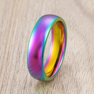 May include: A rainbow iridescent metal ring with a polished finish.