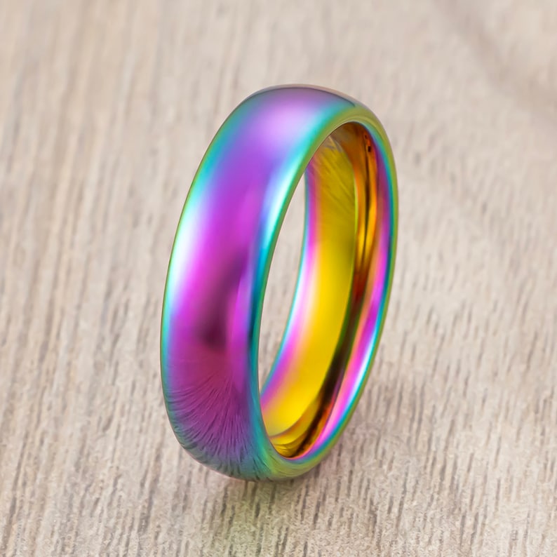 May include: A rainbow iridescent metal ring with a polished finish.