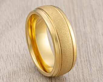May include: A gold-colored wedding band with a brushed finish and a beveled edge.