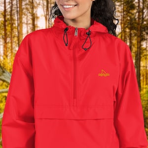 May include: A red hooded jacket with a zipper closure and a small embroidered logo of a sailboat on the front. The jacket has a drawstring hood and elastic cuffs.
