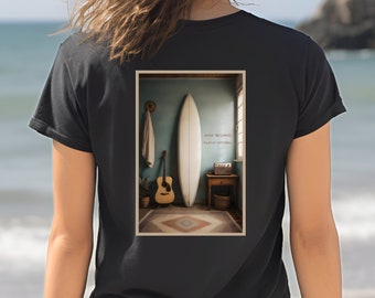 May include: A black t-shirt with a graphic print of a surfboard, a guitar, and a small table in a room with a blue wall. The text on the wall reads "Some things are always better" and "almost effortless".