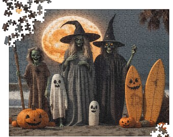 May include: A jigsaw puzzle featuring a Halloween scene with two witches in pointed hats, a ghost, a skeleton figure, and two jack-o'-lanterns on a beach. A large orange moon glows in the background, with two surfboards standing upright in the sand.
