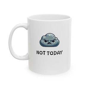Op de afbeelding: Witte keramische mok met een zwart handvat. De mok heeft een cartoonwolk met een boze uitdrukking en de woorden "NOT TODAY" in zwarte, vette letters. De mok is ontworpen voor dranken.