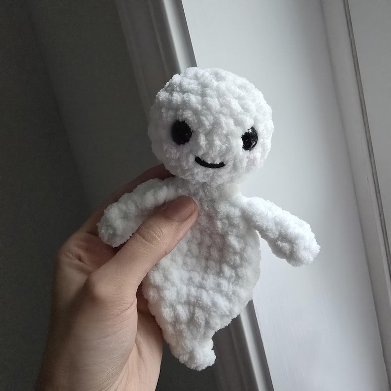 May include: White crocheted ghost plush toy with black eyes and a smiling mouth.