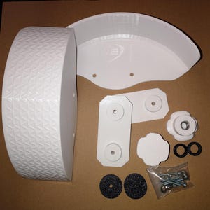 May include: A set of white plastic parts for a 3D printed wheel, including a wheel rim, two brackets, a knob, a small round piece, two black rubber rings, two black round pieces, and a bag of screws.