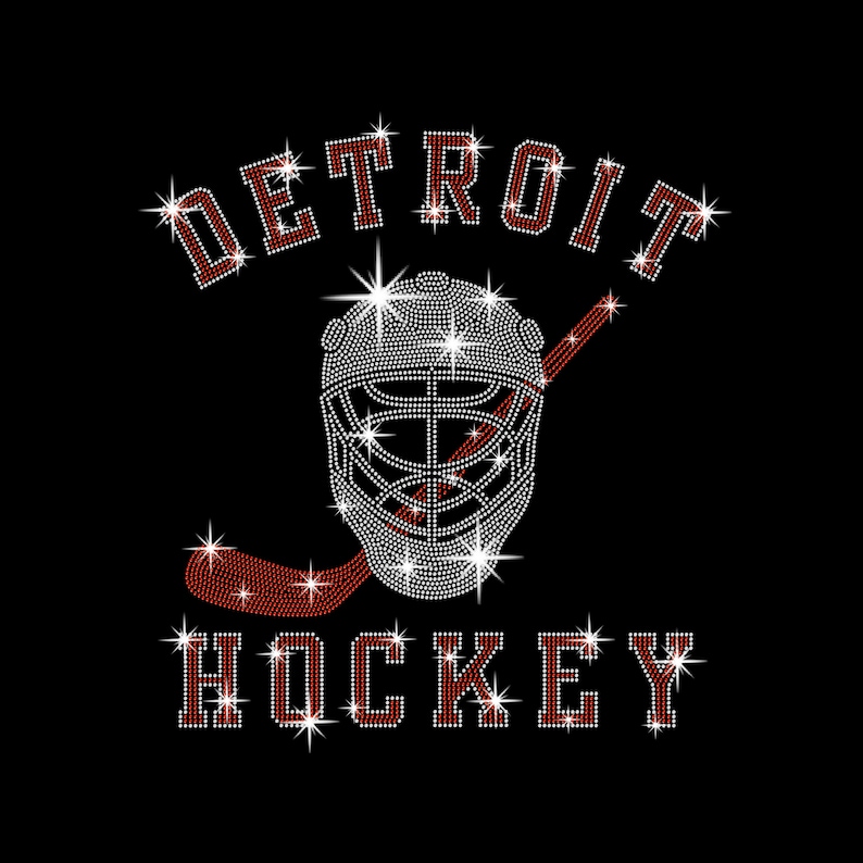 May include: Black graphic with the word "DETROIT" arched above a hockey goalie mask and hockey stick. The word "HOCKEY" is below the mask. All text and the mask are made of white and red rhinestones.