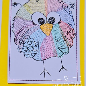 May include: Embroidered design of a colorful bird with large eyes and a yellow beak. The bird is standing on two legs. The design is on a white background with a yellow border and the text "BEE DID THAT designs" at the bottom.