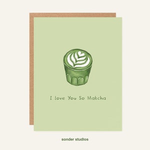 May include: A green and white illustrated greeting card with a green matcha latte and the text "I love you so matcha".