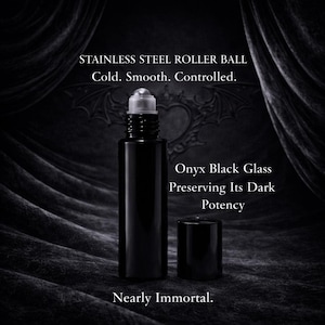 May include: A cylindrical onyx black glass roller bottle with a stainless steel roller ball and a matching black cap. The text on the image reads: STAINLESS STEEL ROLLER BALL Cold. Smooth. Controlled. Onyx Black Glass Preserving Its Dark Potency Nearly Immortal.