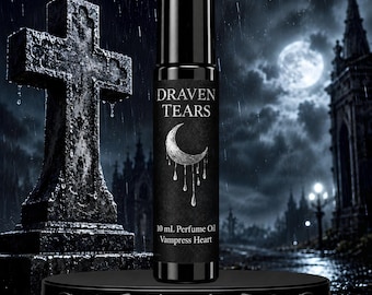 May include: A black cylindrical perfume oil roller bottle with a label featuring a silver crescent moon and dripping liquid graphic. The text on the label reads Draven Tears, 10 mL Perfume Oil, and Vampress Heart in a white serif font.