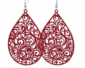 May include: A pair of red teardrop earrings with intricate, openwork floral and swirl designs. The earrings have silver-colored fish hook ear wires. The earrings are a bold, statement accessory.