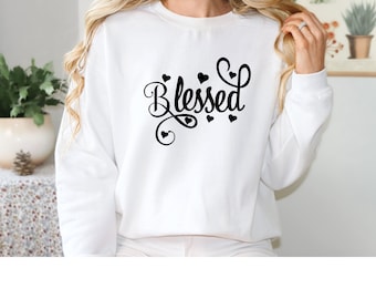 May include: White sweatshirt with the word "Blessed" in black cursive lettering with small hearts around it.
