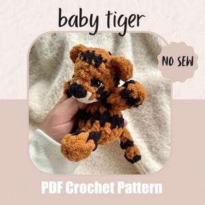 May include: A crocheted baby tiger in shades of brown and black, with the text "baby tiger" above it. The words "NO SEW" are in a circle on the right. Below the tiger is the text "PDF Crochet Pattern".