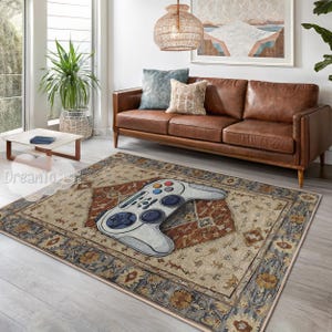 May include: A patterned area rug in beige and brown, featuring a large, light grey video game controller design. The rug has a traditional design with blue and gold accents, in a living room.
