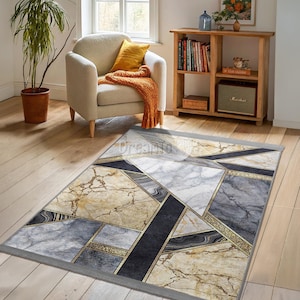 May include: A geometric patterned rug with a marble effect in shades of gray, black, and gold. The rug has a gray border.