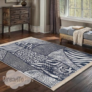 May include: A blue and white area rug with a geometric pattern of animal prints, including zebra, leopard, and snake. The rug has a cream-coloured border.