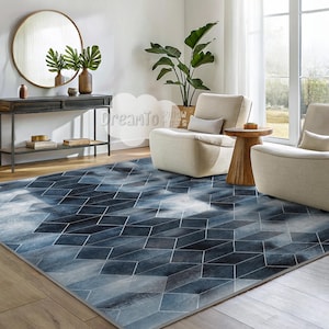 May include: A blue and white geometric patterned rug with a modern design. The rug is in a living room setting with two white armchairs and a wooden side table.