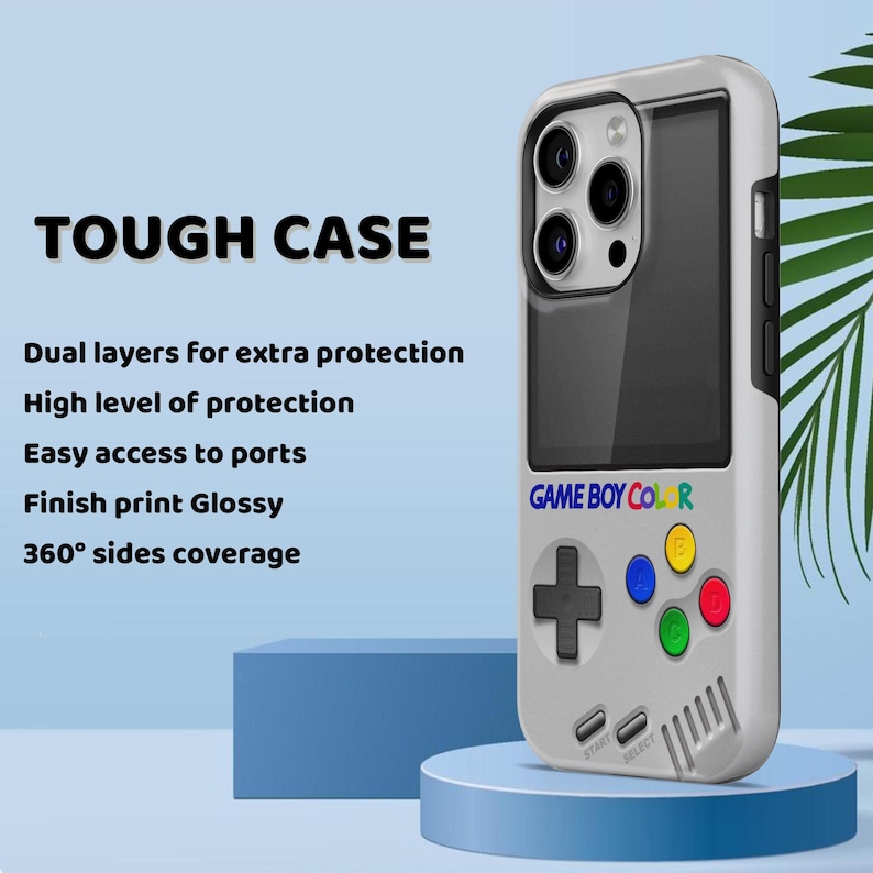 Może przedstawiać: Białe etui na telefon z retro wzorem Game Boy Color. Etui posiada czarny ekran, kolorowe przyciski oraz napis "GAME BOY COLOR". Tekst "TOUGH CASE" znajduje się na g&oacute;rze, z informacjami o ochronie.
