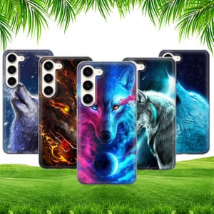 May include: A selection of phone cases with wolf illustrations. The cases showcase diverse wolf designs, including a blue and pink wolf with a planet, a fiery wolf, and a howling wolf against a starry backdrop.