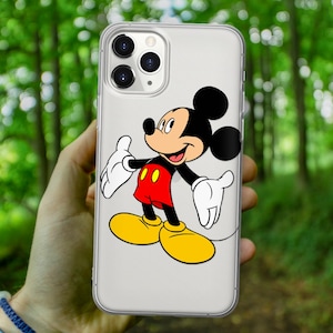 May include: A clear phone case with a black and white Mickey Mouse illustration. Mickey Mouse is wearing red shorts with two yellow buttons and yellow shoes. Mickey Mouse is smiling and has his arms outstretched.