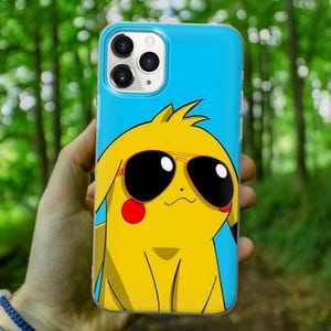 May include: A blue phone case with a cartoon image of a yellow Pikachu wearing sunglasses. The phone case has a cutout for the camera lens.