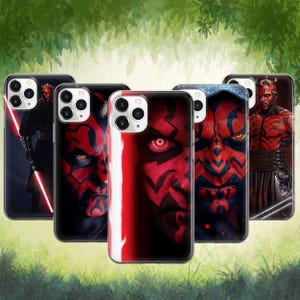 May include: Five phone cases showcasing Darth Maul from Star Wars. The cases feature images of Darth Maul in red and black, some with a red lightsaber. The cases are arranged in a row, with a green background.