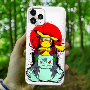 May include: A white phone case with a red and white background. The background features a red circle with a white outline. A yellow Pokemon character with a red headband is standing on top of a green Pokemon character. The yellow Pokemon character is holding its arms crossed and the green Pokemon character is holding a pipe.