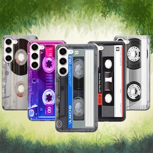 May include: A collection of five phone cases with cassette tape designs. The cases feature various colors, including clear, pink, black, and gray, with details like labels and reel designs. The "SONY" logo is visible on one case.