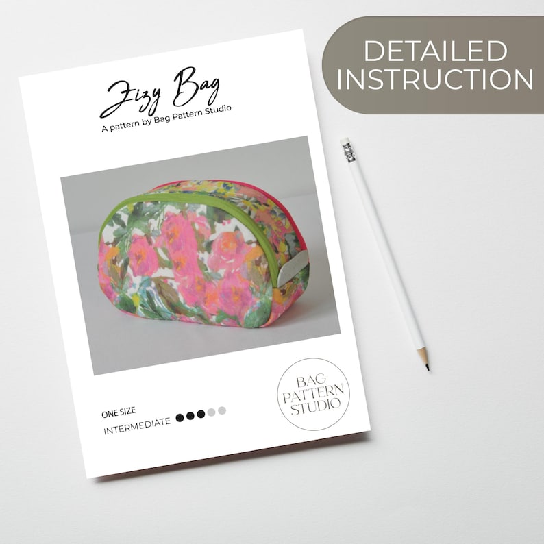 May include: A sewing pattern for a small, oval-shaped bag called "Jizzy Bag". The bag is made of fabric with a floral print in shades of pink, green, and white. The pattern is by Bag Pattern Studio and is labeled as "one size" and "intermediate" difficulty.