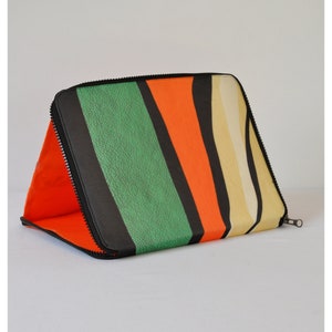 May include: A black, green, orange, and cream striped laptop sleeve with a zipper closure.