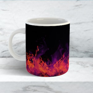 May include: White ceramic mug with a fiery design in orange, red, and purple hues set against a black backdrop. The mug has a standard handle and a glossy finish, ideal for hot drinks.