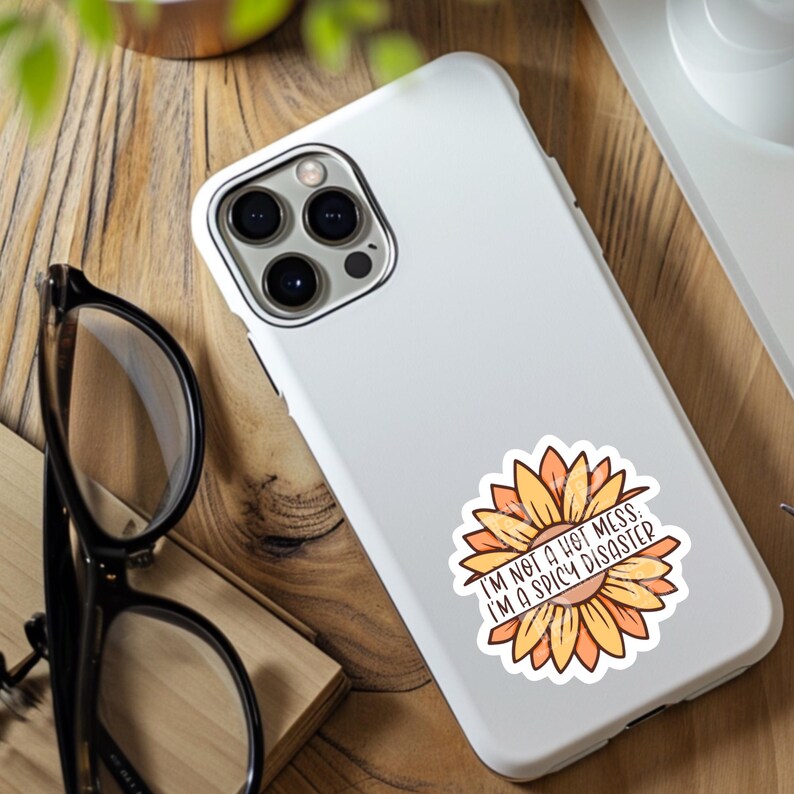 May include: White phone case with a sunflower graphic and the text "I'm not a hot mess, I'm a spicy disaster."