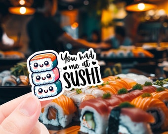 May include: A sticker with a cartoon sushi roll and the text "You had me at sushi" with hearts around the word "me".