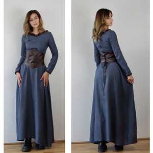May include: A long, blue dress with a brown leather corset belt. The dress has long sleeves and a ruffled neckline.