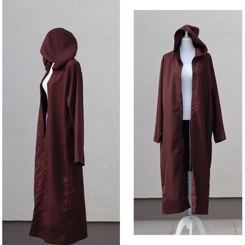 May include: A long, maroon hooded robe with a simple design. The robe is open in the front and has a hood that can be pulled up over the head.