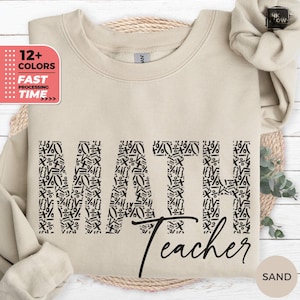 以下が含まれることがあります： 数学の記号を使って黒で「MATH」と綴られたベージュのトレーナー。 「Teacher」という言葉は「MATH」の下に筆記体で書かれています。