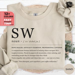 Könnte beinhalten: Sandfarbener Pullover mit den schwarzen Buchstaben "SW" und einer Definition darunter. Der Text enthält "HOPE DEALER, ADVOCACY CHAMPION, PROFESSIONAL LISTENER". Das Bild zeigt auch eine Grafik mit "12+ COLORS" und "FAST PROCESSING TIME".