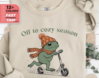 Felpa "Off To Cozy Season" - Divertente felpa invernale con rana e scooter