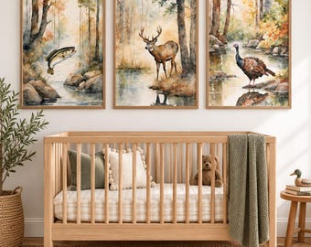 May include: A light wood cot with a plaid sheet, two throw pillows, and a green blanket. Above the cot are three framed watercolour prints depicting a jumping fish, a standing deer, and a turkey in a forest setting near a stream.