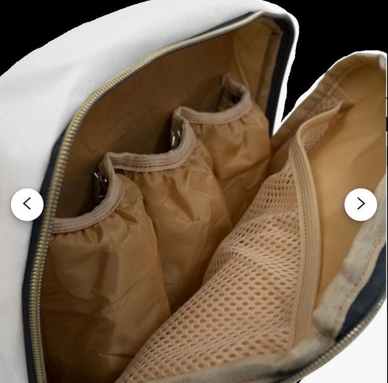 May include: A white canvas backpack with a black zipper and brown mesh lining. The backpack has multiple pockets and compartments.