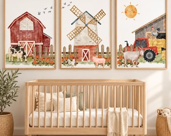 May include: Three framed wall art prints featuring watercolor farm scenes. The first shows a red barn and cow, the second a windmill with a pig and chicken, and the third a red tractor, goat, and sun. Each print includes a wooden fence and flowers.