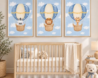 May include: Three framed wall art prints featuring a zebra, a lion, and a giraffe, each riding in a blue and cream hot air balloon against a light blue sky with white clouds. The illustrations are set in light wood frames.