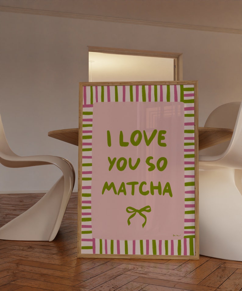 May include: A framed pink and green striped poster with the text "I love you so matcha" in green lettering and a green bow.