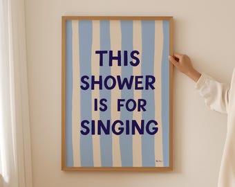 May include: A framed print with blue and white stripes and the text "This shower is for singing".