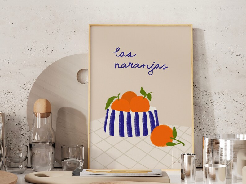 May include: A printable art print with a blue and white striped bowl filled with orange fruit. The text "las naranjas" is written in blue cursive script above the bowl.