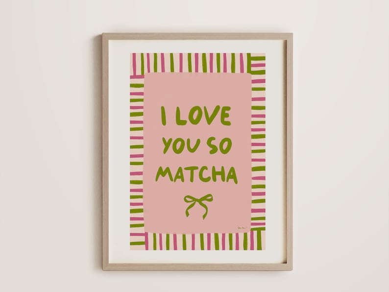 May include: A framed print with pink and green stripes, featuring the text "I love you so matcha" and a green bow.
