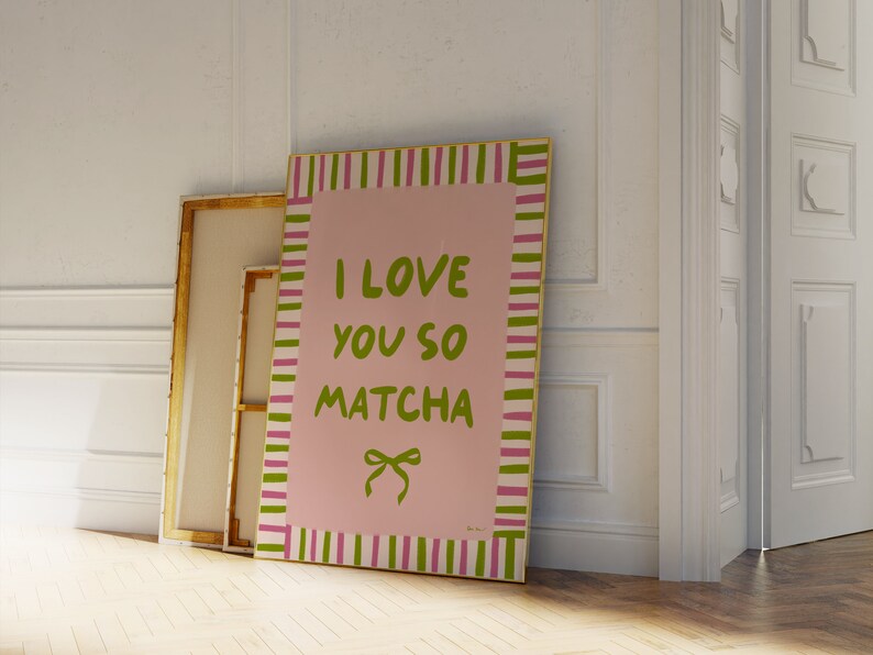 May include: A pink and green striped framed canvas print with the text "I love you so matcha" in green lettering and a green bow.