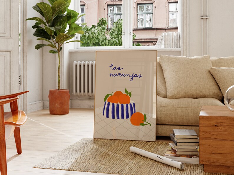 May include: A framed print with a blue and white striped bowl filled with orange fruit. The text "las naranjas" is written in black above the bowl.